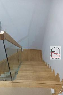 Лестница с дубовыми ступенями на металлическом каркасе со стеклянным ограждением